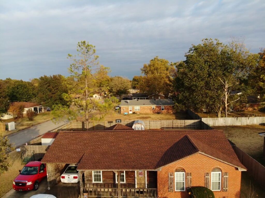 Aerial view of home with shingle roof.