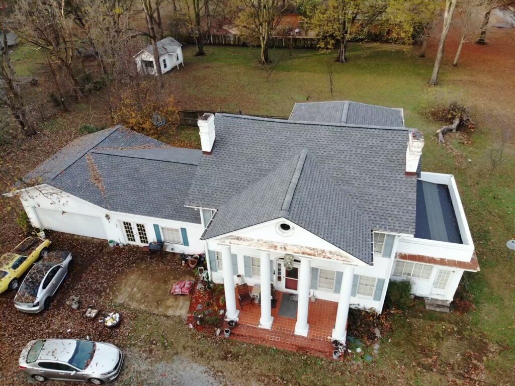 Aerial view of home with shingle roof.