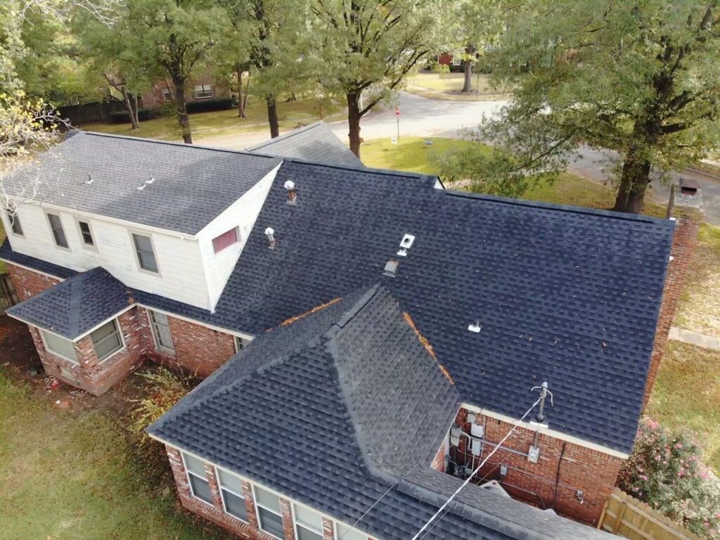 Aerial view of home with shingle roof.