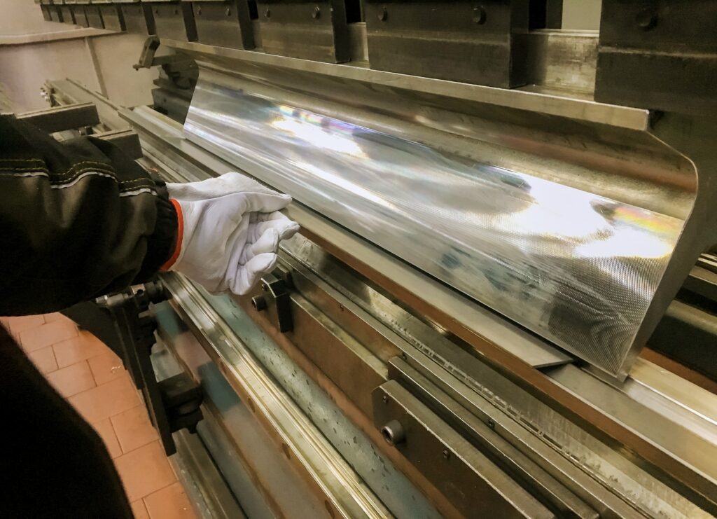 Man working on custom sheet metal fabrication.